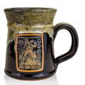 The front of the Bones Coffee Company Army of Dark Chocolate Handthrown Mug. It has the Army of Dark Chocolate art on the golden medallion. The mug is gloss black colored with a sunshine and white glaze.