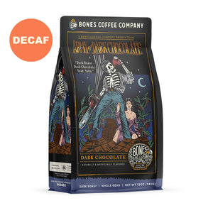 The front of a 12 ounce bag of Bones Coffee Company Army of Dark Chocolate coffee. Its flavor is dark chocolate, and it has a skeleton wielding a chainsaw standing on dark chocolate with a woman clinging to its leg on the art. There is a sticker saying decaf.