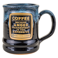 The front of the Bones Coffee Company Anger Management Handthrown Mug. It has the phrase “Coffee, because anger management is too expensive” on the golden medallion. The mug is black colored with a powder blue and white glaze.