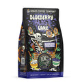 The front of a 12 ounce bag of Bones Coffee Company Blueberry Blast Cake flavored coffee. Its flavor is blueberry pancakes. The art shows a skeleton using a bow and arrow with a blueberry on the tip shooting at pancake targets on it.