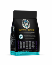 The back of a 12 ounce flavored coffee bag inspired by Disney Haunted Mansion named Brownie From Beyond. The Rain Forest Alliance page on the lower left of the back of the bag and it says to squeeze and sniff at the top of the bag. Near the bottom of the bag are busts from Disney Haunted Mansion.