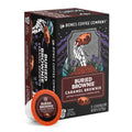 A boxed coffee product and one single-serve cup from Bones Coffee Company, both labeled Buried Brownie Caramel Brownie. The box is dark brown with illustrated skeleton hands holding a brownie and purple floral accents.