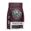The front of a 12 ounce bag of Bones Coffee Company Dragon’s Lair coffee. It is a dark roast, and it has a dragon around the Bones Coffee Company logo on the art.