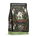 The front of a 12 ounce bag of Bones Coffee Company Ethiopia single-origin coffee. It is a light roast, and it has a goat chewing on a coffee branch with other coffee branches and goats scattered around it on the art.