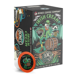 The front of the Bones Coffee Company Irish Cream 12 Count Bones Cups box. Its flavor is irish cream, and it has a skeleton dressed up as a leprechaun holding a pot of coffee beans and a tankard on the art.