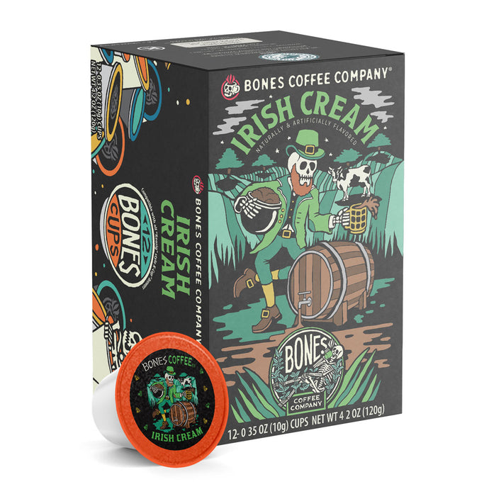 The front of the Bones Coffee Company Irish Cream 12 Count Bones Cups box. Its flavor is irish cream, and it has a skeleton dressed up as a leprechaun holding a pot of coffee beans and a tankard on the art.