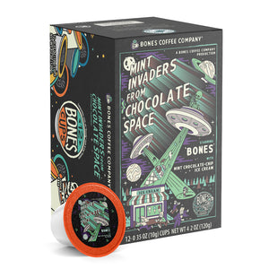 The front of the Bones Coffee Company Mint Invaders from Chocolate Space 12 Count Bones Cups box. Its flavor is mint chocolate chip ice cream, and it has green skeletons abducting ice cream and people into their UFOs on the art.
