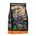 The front of a 12 ounce bag of Bones Coffee Company Orange-Sickle flavored coffee. It is orange vanilla cream flavored, and It has a skeleton holding an orange popsicle over its shoulder dressed as the grim reaper on the art. 