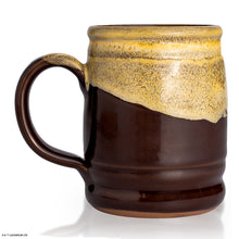 The back of the Bones Coffee Company Toffee Treasure hand thrown mug. It is brown colored and has a white glaze on top of it.