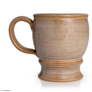 The back of the Bones Coffee Company Crusader's Cup hand thrown mug. It is tan colored.