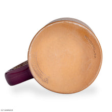 The bottom of the Bones Coffee Company Daring Delight hand thrown mug. It is purple colored and has a white glaze on top of it.