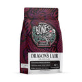 The front of a 12 ounce bag of Bones Coffee Company Dragon’s Lair coffee. It is a dark roast, and it has a dragon around the Bones Coffee Company logo on the art.