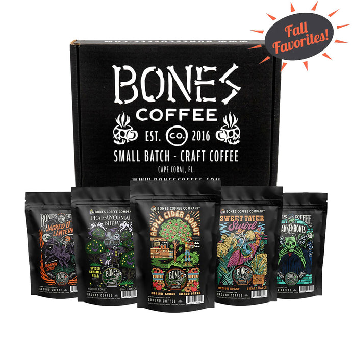 Five bags of four ounces of flavored coffee. From left to right their names are Jacked O' Lantern, Pear-anormal Brew, Apple Cider Donut, Sweet Tater Swirl, and Frankenbones. A box is behind it that says Bones Coffee. There is a sun above them that says Fall Favorites.