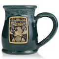 The front of the Bones Coffee Company Frog’s Breath hand thrown mug with Sally from Tim Burton’s The Nightmare Before Christmas on the golden medallion. The mug is green colored with a white glaze on top.