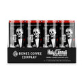A 12-pack of cold brew lattes. Inside the pack is the Holy Cannoli cold brew lattes. The art has a skeleton dressed in a suit with a red rose on the lapel holding a cannoli like a cigar.