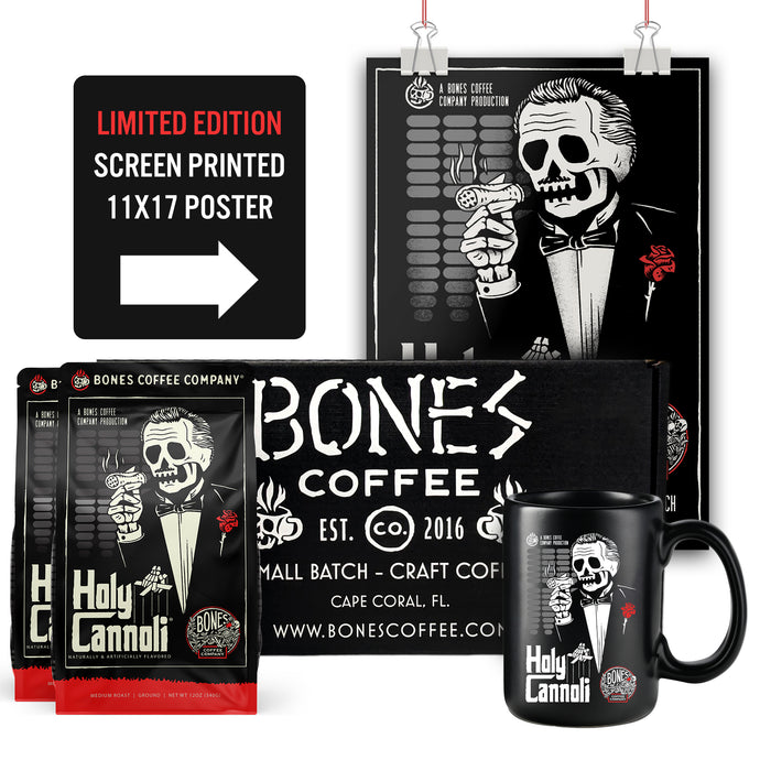 The Holy Cannoli bundle box has two 12 ounce bags of cannoli flavored coffee named Holy Cannoli. There is a poster that is screen posted measuring 11 by 17 and a black mug showing the art of the Holy Cannoli coffee.