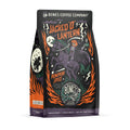 The front of a 12 ounce bag of Bones Coffee Company Jacked O’ Lantern coffee. Its flavor is pumpkin spice, and it has a skeleton with a pumpkin on its head riding a horse on the art. 