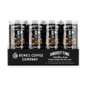 A 12-pack of cold brew lattes. Inside the pack is the S’morey Time cold brew lattes. A single can of this cold brew latte is on the side and has a skeleton holding a flashlight with bigfoot and a werewolf around a campfire making s’mores on the art.