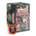 The front of the Bones Coffee Company Strawberry Cheesecake 12 Count Bones Cups box. Its flavor is strawberry cheesecake, and it has a skeleton with a button-down shirt falling into a red and white swirl with cheesecake and strawberries on the art.