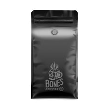 The back of a 12 ounce bag of coffee. Near the bottom is the Bones Coffee Company logo with a skull that looks like a mug with steam coming out of the top.