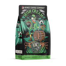 The front of a 12 ounce bag of Bones Coffee Company Irish Cream coffee. Its flavor is irish cream, and it has a skeleton dressed up as a leprechaun holding a pot of coffee beans and a tankard on the art.