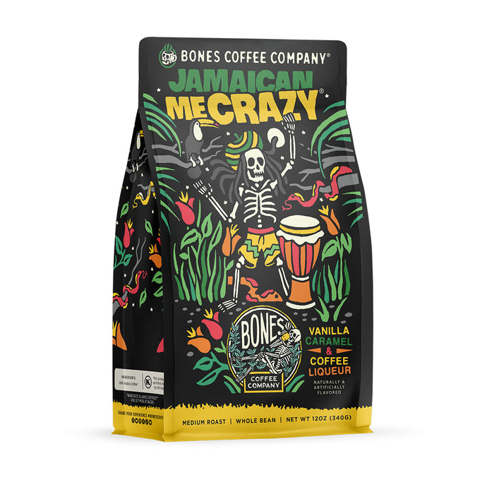 The front of a 12 ounce bag of Bones Coffee Company Jamaican Me Crazy coffee. Its flavor is vanilla, caramel, and coffee liqueur, and it has a skeleton wearing a hat with dreadlocks dancing around with a bongo nearby on the art. 