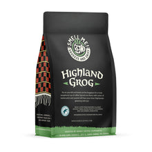 The back of a 12 oz flavored coffee bag named Highland Grog. The Rain Forest Alliance page on the lower left of the back of the bag, and it says to squeeze and sniff at the top of the bag. Below the squeeze and sniff text is the name Highland Grog.