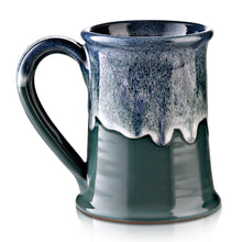 The back of the Salty Siren mug that is seafoam colored with an ocean blue glaze on top of it.