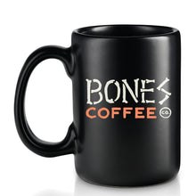 The back of the Bones Coffee Company classic logo mug. It is colored black and has the Bones Coffee Company logo on it that says Bones Coffee Co with the words bones spelled out with bones.