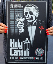The Holy Cannoli poster being held by someone.