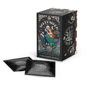 A box and cold brew pods of flavored coffee named Salty Siren. Its flavor is sea salted caramel mocha, and its art shows a skeleton dressed up as a sailor holding a mermaid.