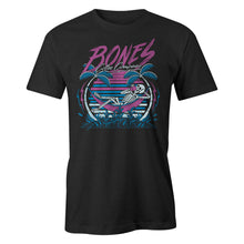 The front of the men's Retro Summer tee shirt. They're colored black and have art of a skeleton sipping coffee in a hammock between two palm trees before a retro colored sun.