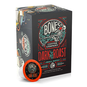 The front of the Bones Coffee Company Dark Roast 12 Count Bones Cups box. It has the Bones Coffee Company logo that has a skeleton sipping coffee, lounging on greenery around it on the art.