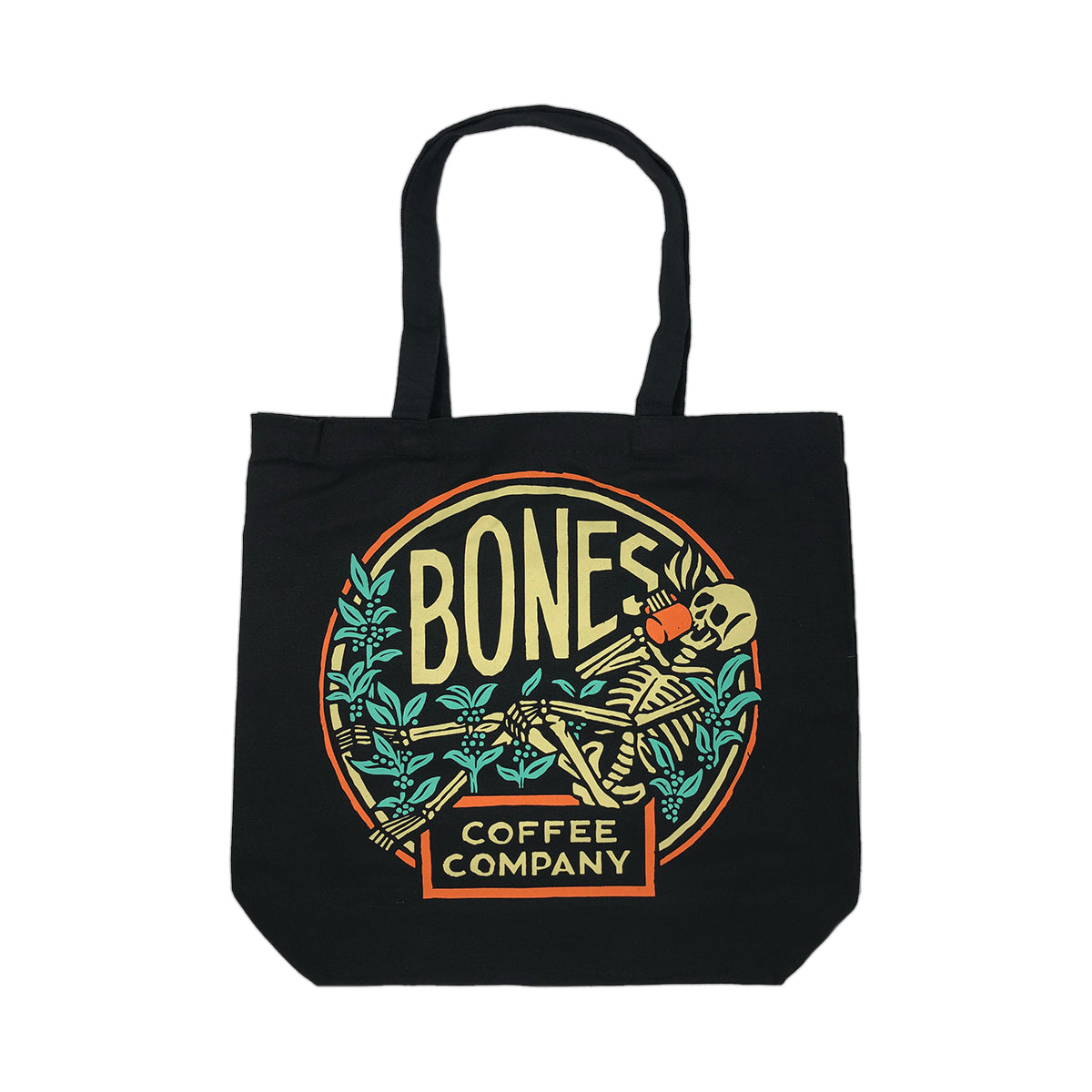 A black tote bag that has the classic Bones Coffee Company logo on it. The logo has a skeleton drinking coffee resting on greenery on it.