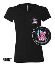 The front of the women's What The Fluff tee shirt. It is colored black and has a small logo of a teddy bear that's missing an ear and grinning maniacally while holding a cotton candy stick.