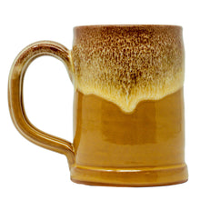 The back of the Wunderbones tankard. It is mustard colored with a cinnamon-white glaze on top of it.