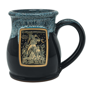 The front of the Bones Coffee Company Army of Dark Chocolate hand thrown mug with the Army of Dark Chocolate coffee art on the golden medallion. The mug is black colored and has a powder-blue glaze on top of it.