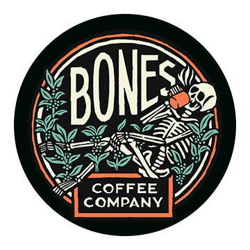 Bones Coffee Company logo, showing a skeleton leaning back and drinking a cup of coffee, surrounded by greenery