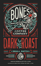 The art for Dark Roast. Its has the Bones Coffee Company logo that has a skeleton sipping coffee, lounging on greenery around it.