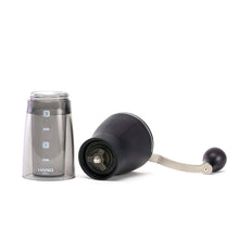 A black colored Hario mini-slim plus ceramic coffee mill that is taken apart.