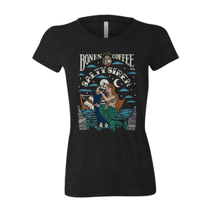 The front of the women's Salty Siren tee shirt. It is colored black and has the art of the Army of Dark Chocolate coffee on it. There is a skeleton wearing a sailor's outfit carrying a mermaid while its ship sinks in the background on its art.